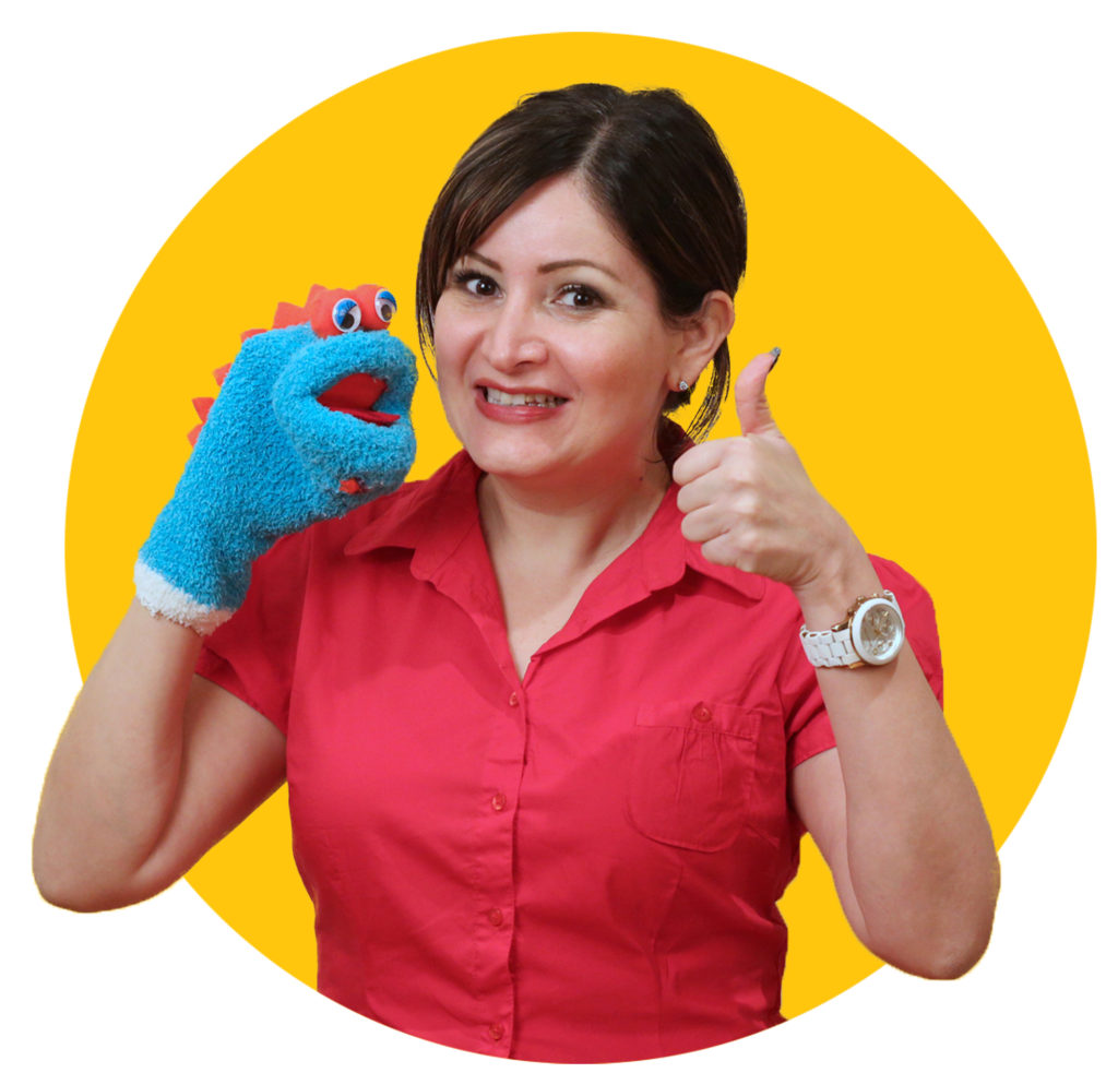 Profesora Mary giving a thumbs up sign and smiling with Puppet Beto